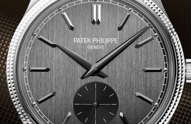 Front-facing close photograph of the charcoal-grey Calatrava 6119G dial and hobnail bezel