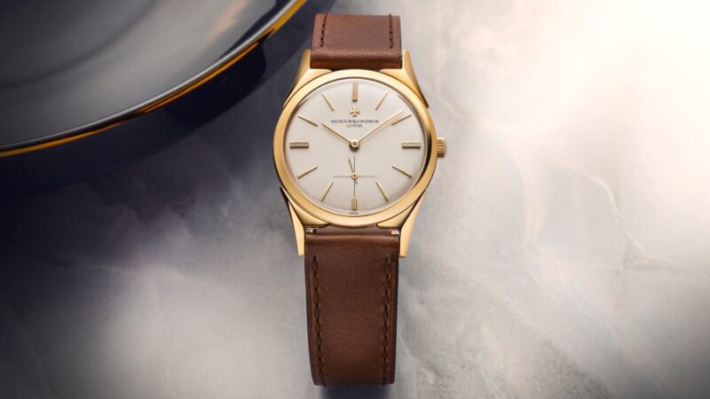 Vintage gold Vacheron Constantin watch photographed beside a dark dish