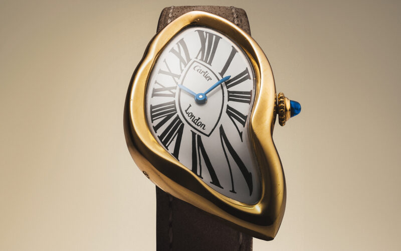 Asymmetrical gold watch with Roman-numeral dial photographed by Christie’s