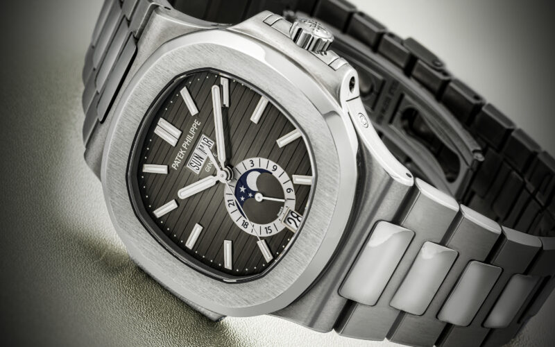 Close photograph of a dark-dial steel bracelet watch published by Christie’s