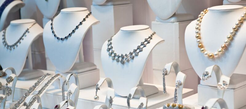 Necklaces, earrings and bracelets displayed on individual jewellery stands