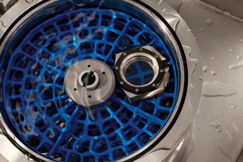 Audemars Piguet watch case components arranged in water-resistance testing equipment