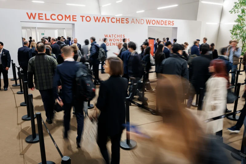 Visitors entering Watches and Wonders Geneva 2026 beneath the event signage