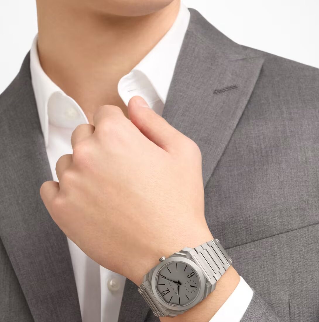 Bulgari Octo Finissimo 37mm titanium worn on the wrist with grey tailoring