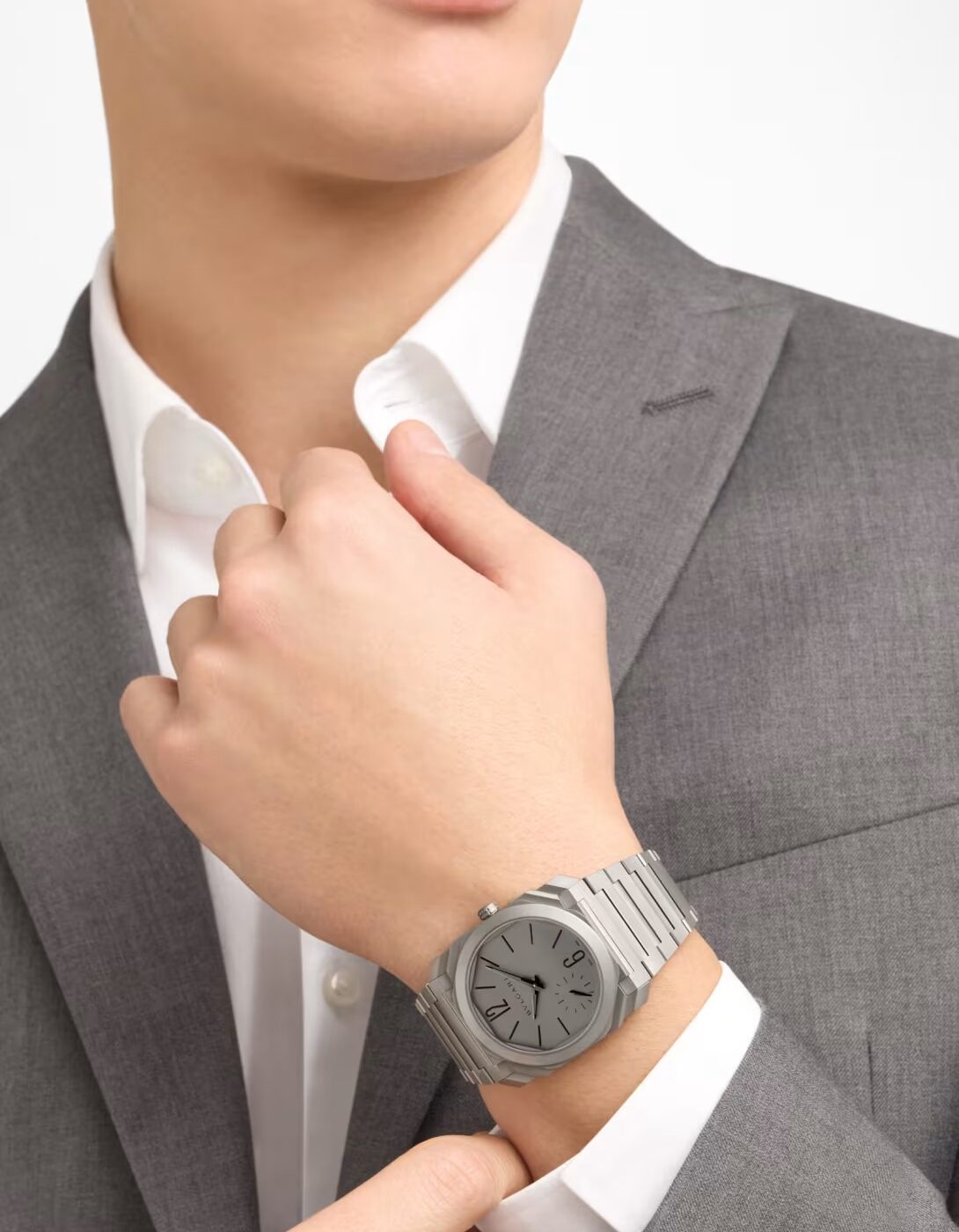 Bulgari Octo Finissimo 37mm titanium worn on the wrist with grey tailoring