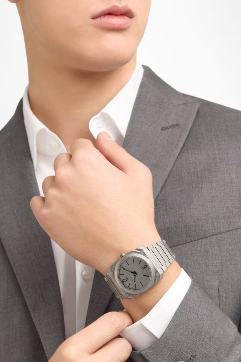 Bulgari Octo Finissimo 37mm titanium worn on the wrist with grey tailoring