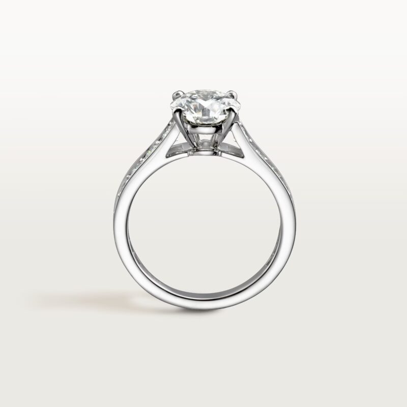 Studio shot of the classic Cartier Trinity ring featuring three interlocking bands of white, yellow, and rose gold
