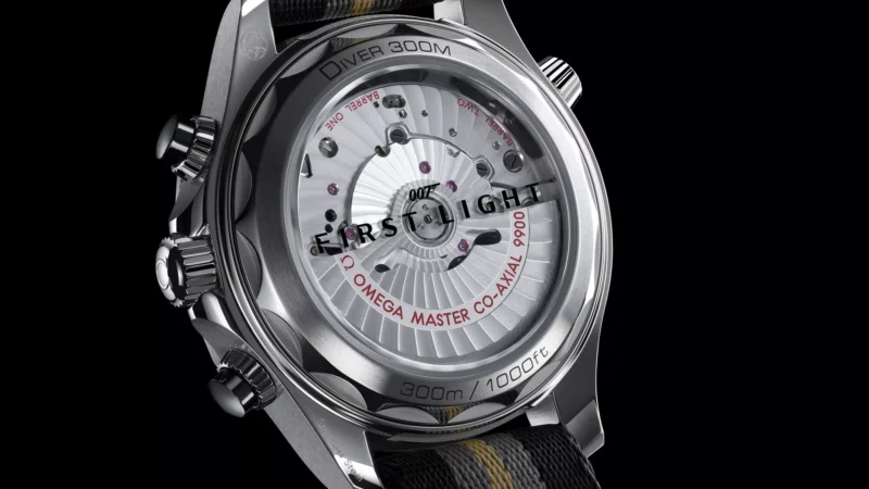 Landscape close-up view of the Omega Seamaster Diver 300M Chronograph 007 First Light sapphire caseback and NATO strap