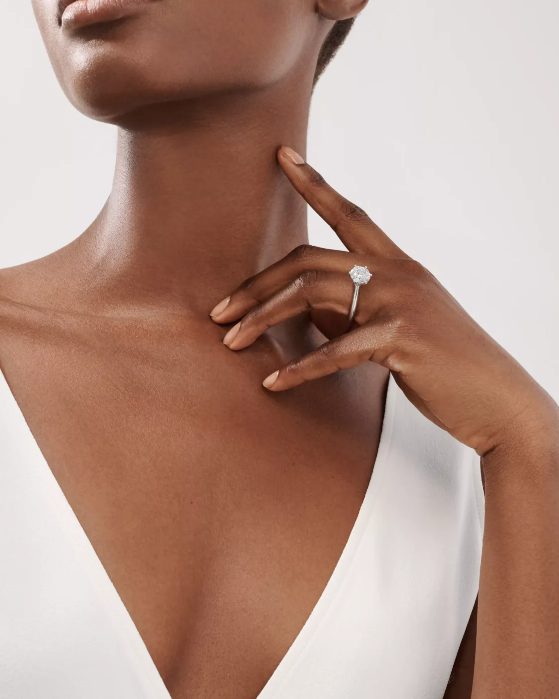 A profile view of the classic rose gold Tiffany Setting solitaire ring showcasing the elevated six-prong diamond head