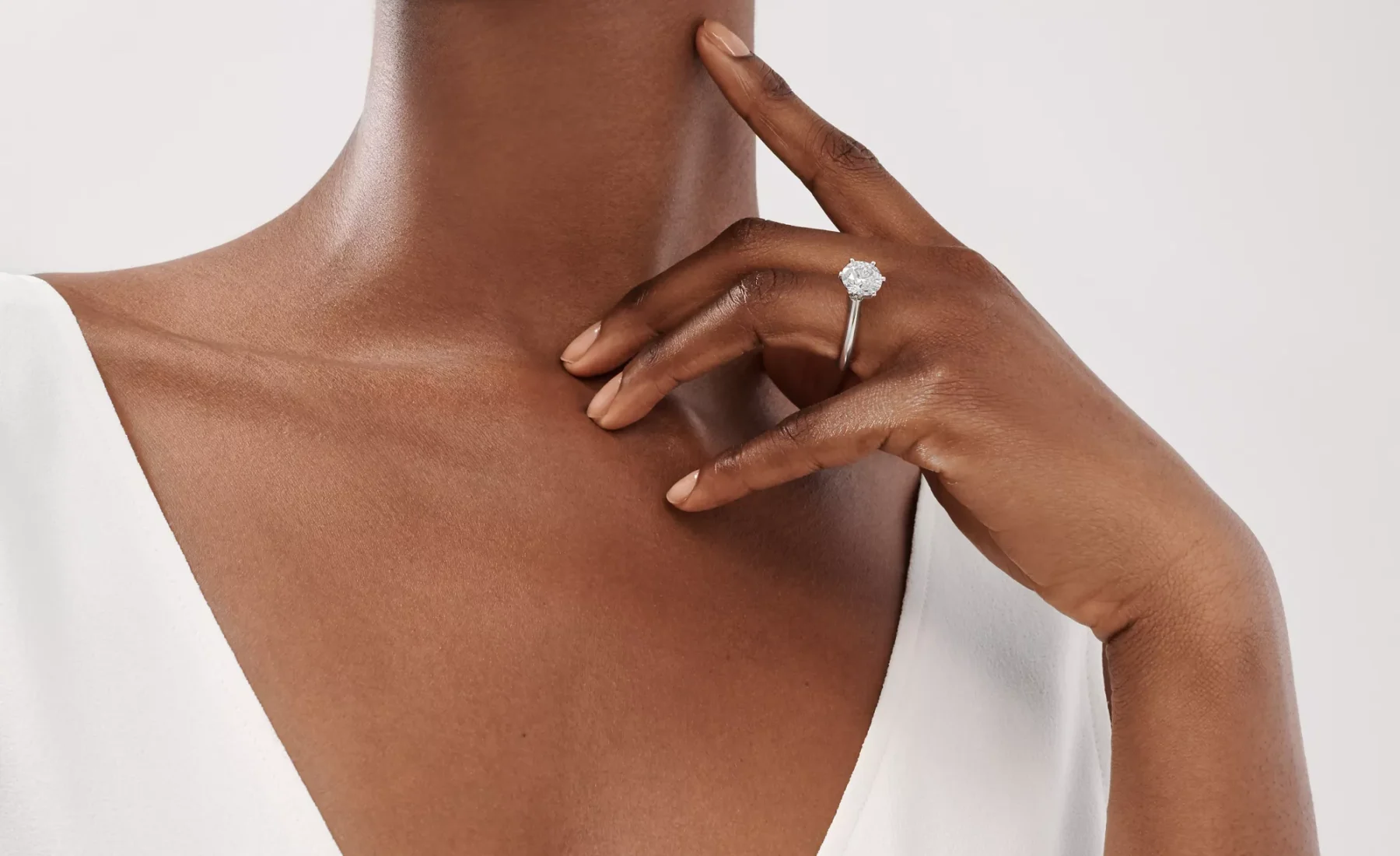 A profile view of the classic rose gold Tiffany Setting solitaire ring showcasing the elevated six-prong diamond head