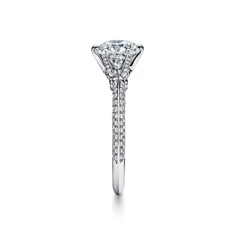 Angled view of the rose gold Tiffany Soleste pear-shaped diamond engagement ring with a single pave halo and diamond band