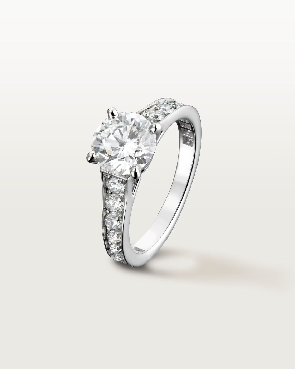 A studio shot of the Cartier Trinity ring variant with one band set with pave diamonds and two plain bands