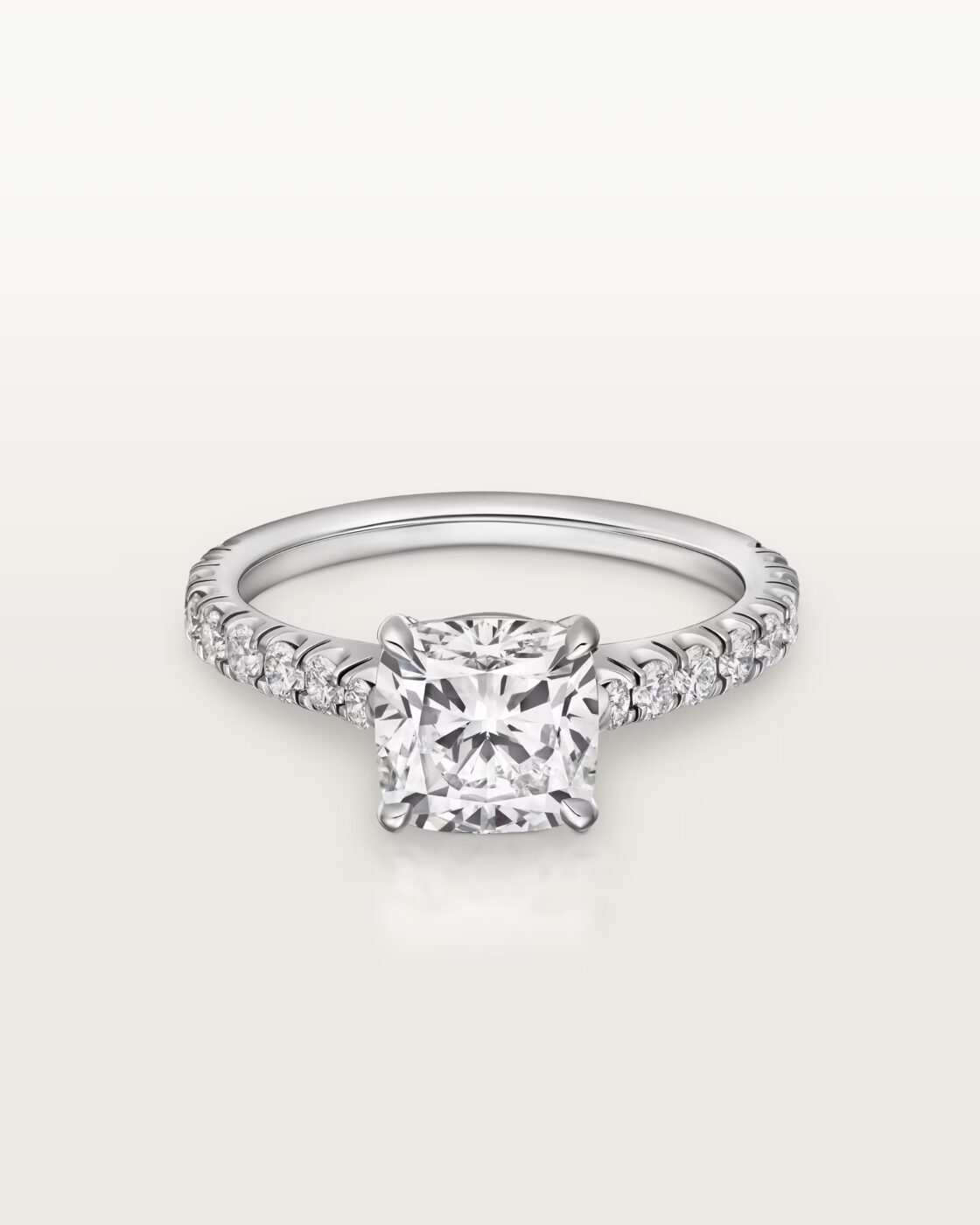 Studio shot of the Cartier Solitaire 1895 ring featuring a pave-set diamond band and a brilliant-cut center diamond