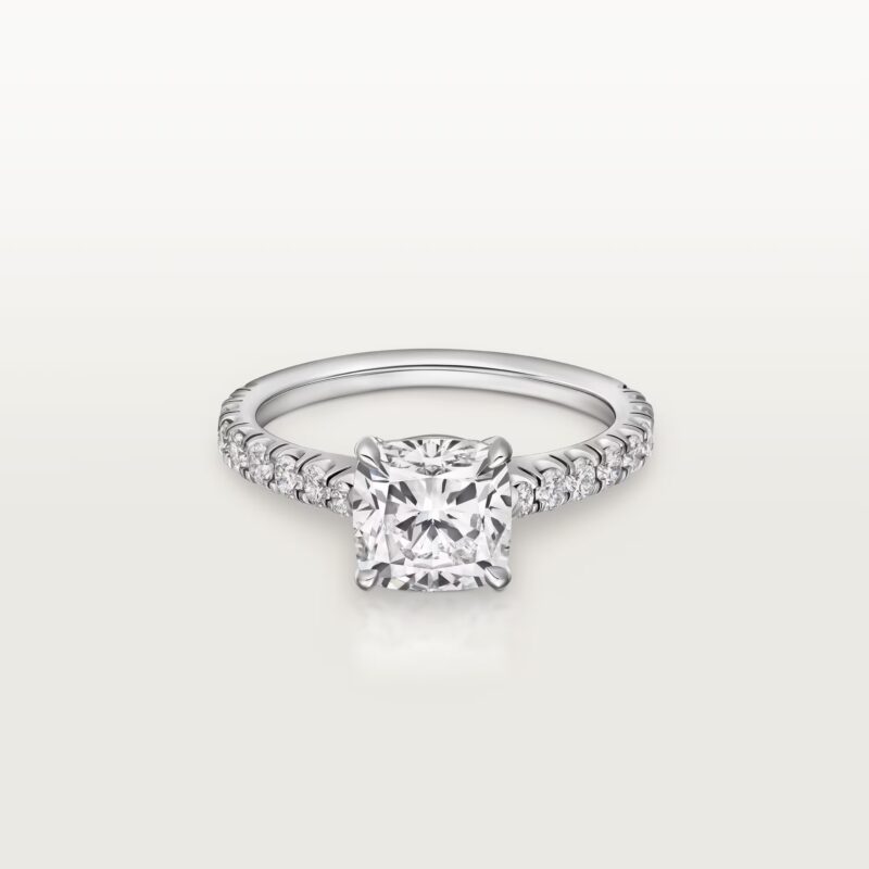Studio shot of the Cartier Solitaire 1895 ring featuring a pave-set diamond band and a brilliant-cut center diamond