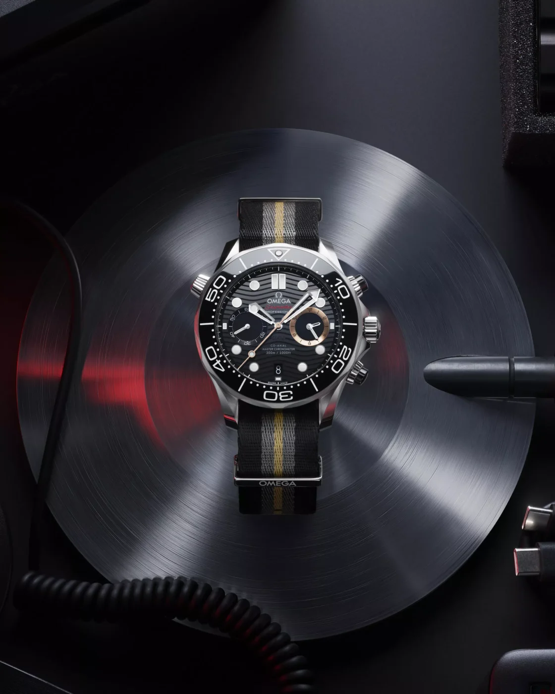 Portrait lifestyle view of the Omega Seamaster Diver 300M Chronograph 007 First Light on a gear reel