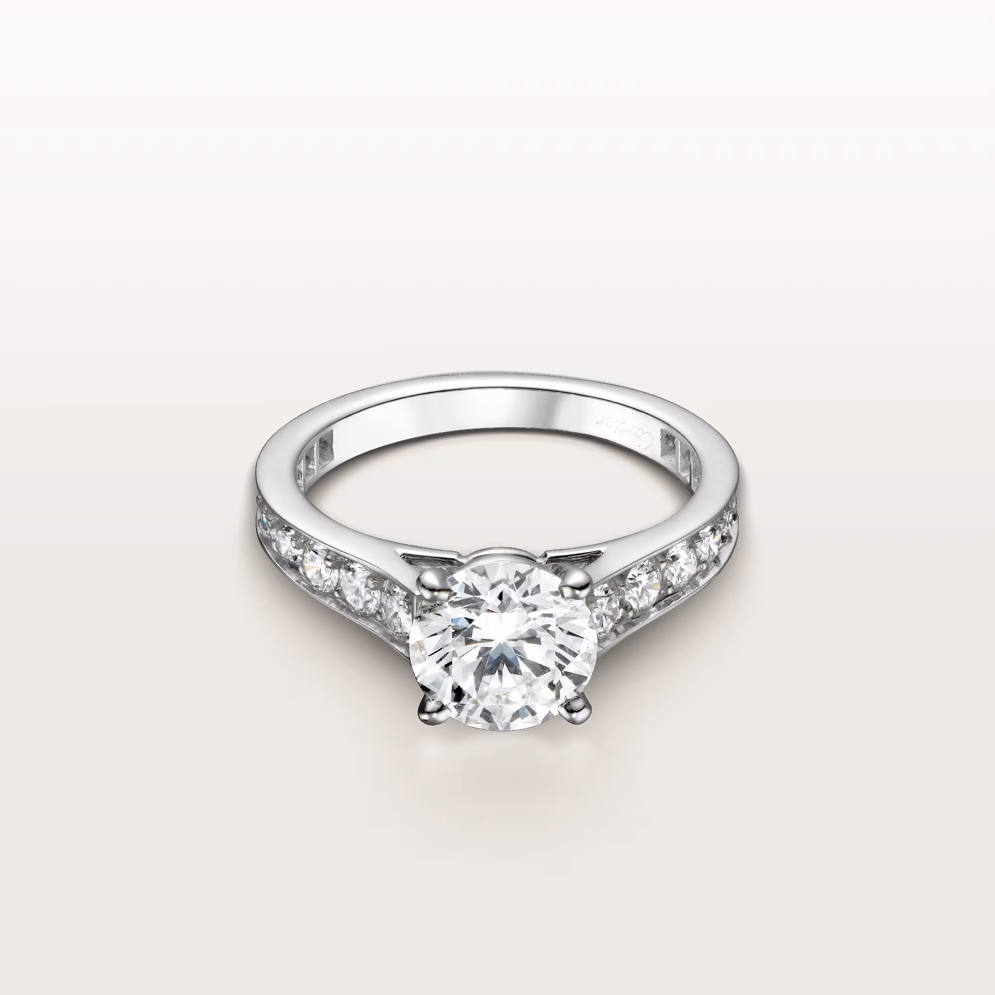 Close-up lifestyle photograph of a model's hand wearing the plain Cartier Trinity ring