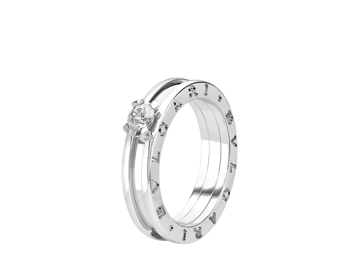 Bulgari B.zero1 rose gold and black ceramic spiral ring on a light grey background