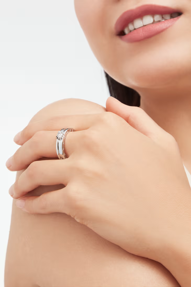 Side profile view of a model hand displaying a Bulgari B.zero1 white gold and diamond ring