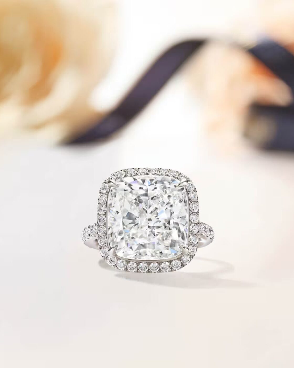 Detailed studio view of the Harry Winston The One cushion-cut diamond solitaire ring featuring a micropave halo and band