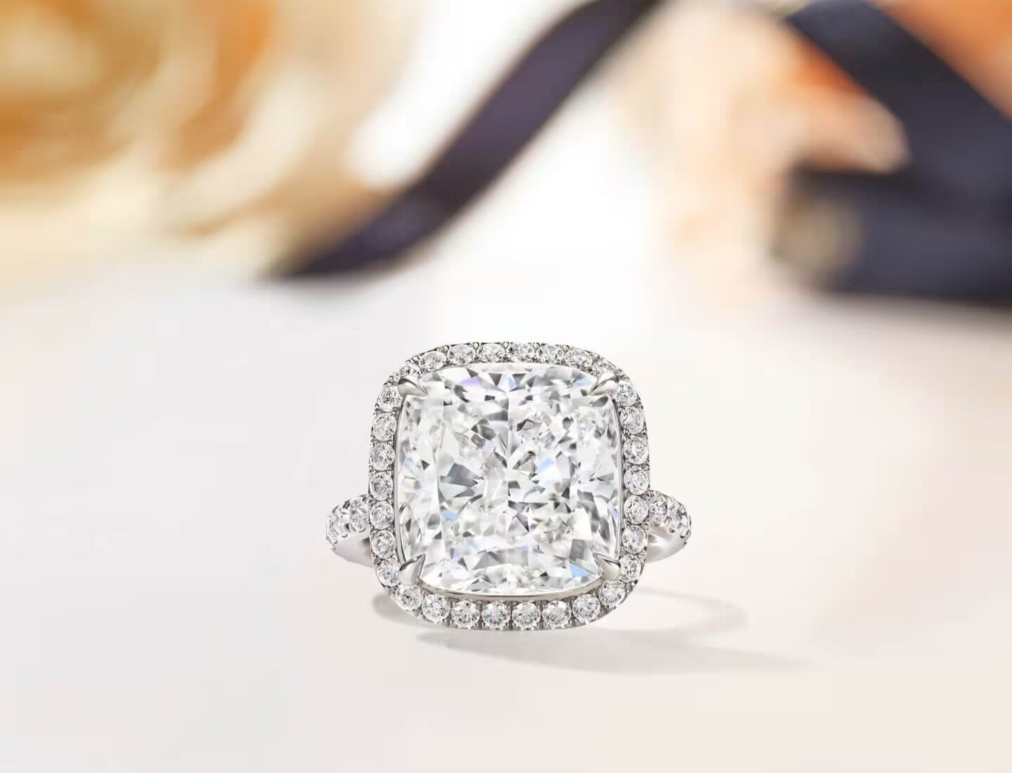 Detailed studio view of the Harry Winston The One cushion-cut diamond solitaire ring featuring a micropave halo and band