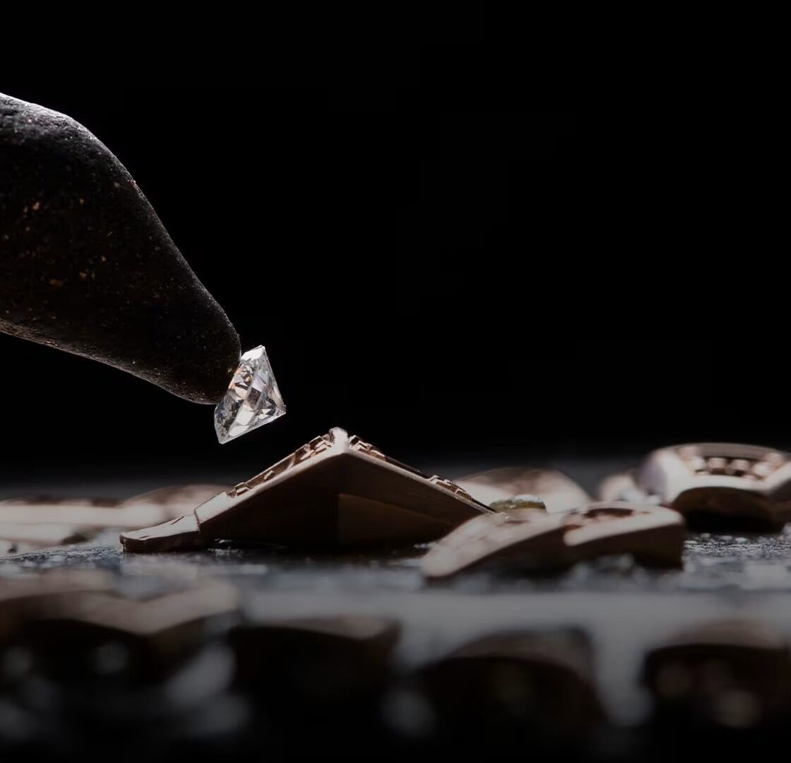 A master craftsman at the Bulgari high jewellery workshop placing diamonds into an intricate pave setting