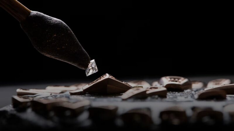A master craftsman at the Bulgari high jewellery workshop placing diamonds into an intricate pave setting
