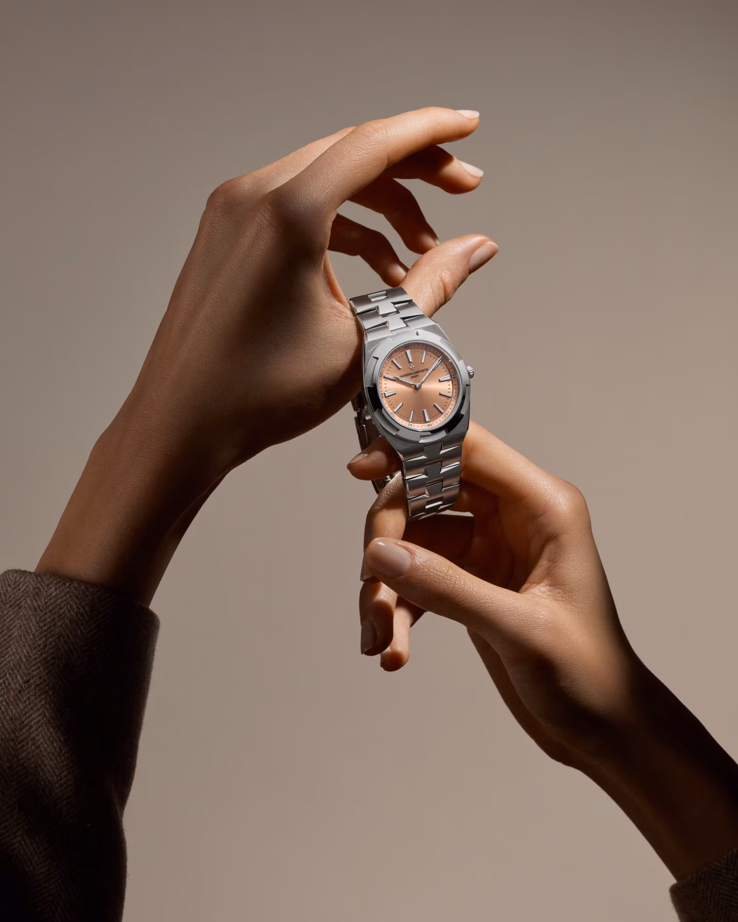Vacheron Constantin Overseas Self-Winding Ultra-Thin held in hand with salmon dial