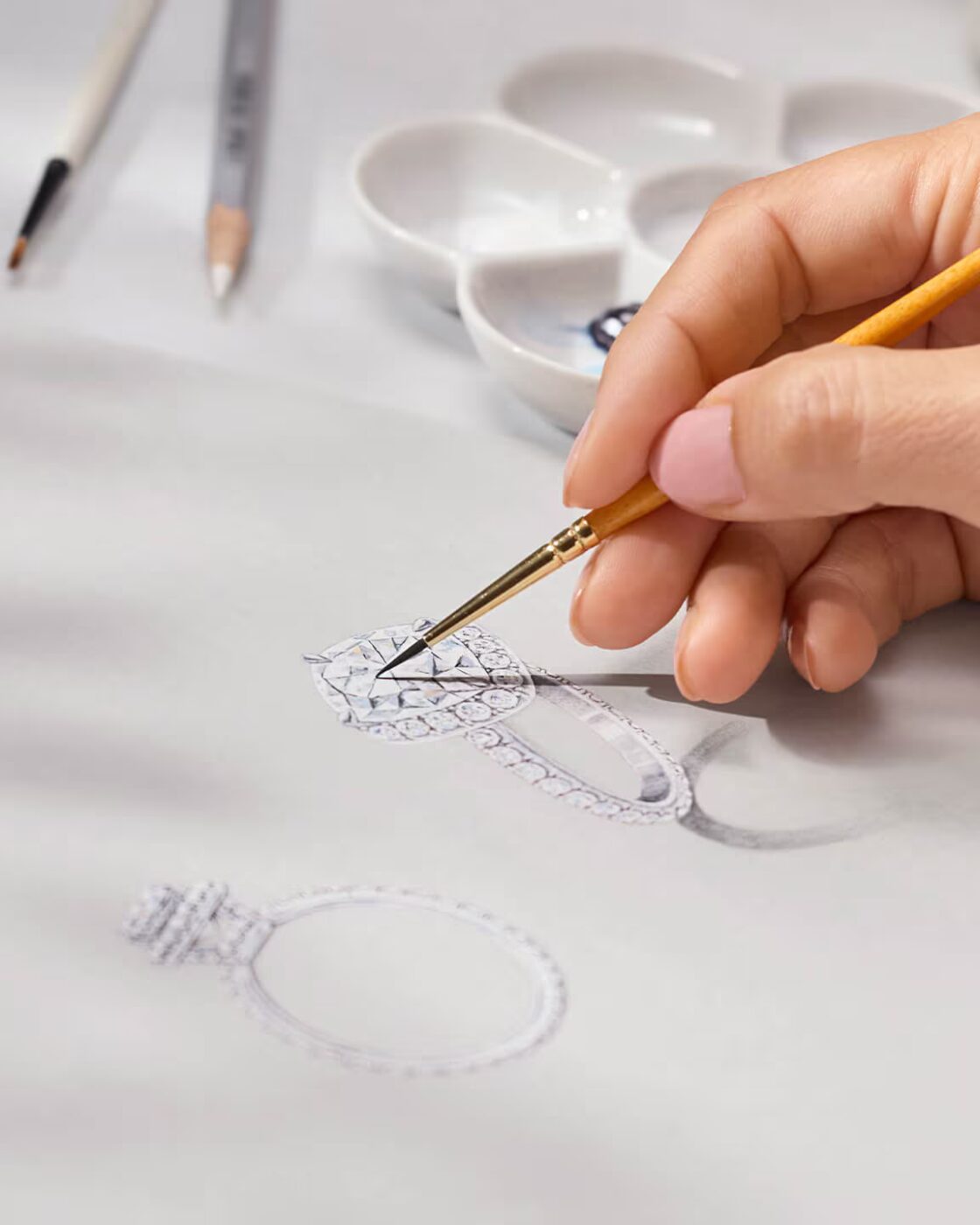A delicate pencil and watercolour design drawing of a Harry Winston solitaire engagement ring showing stone placement details