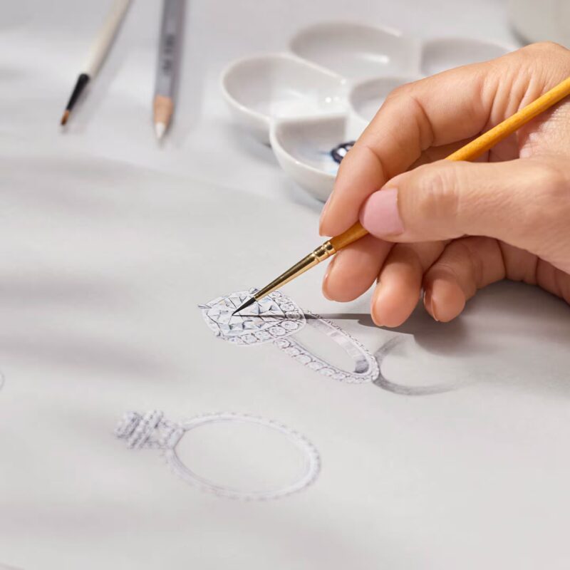 A delicate pencil and watercolour design drawing of a Harry Winston solitaire engagement ring showing stone placement details