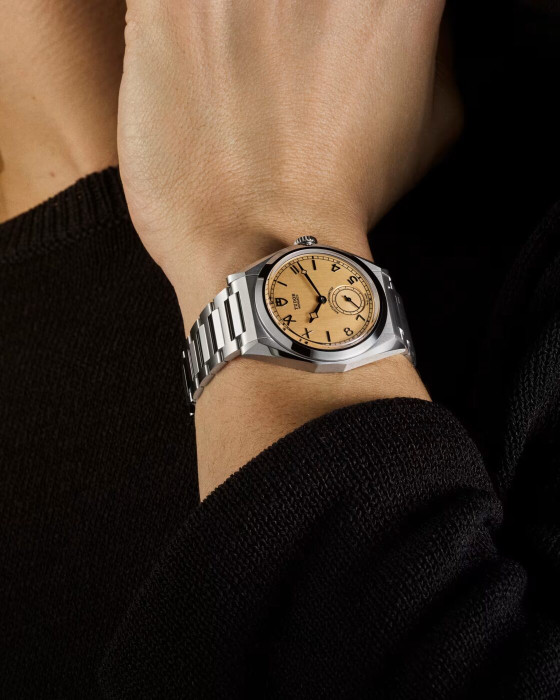 Tudor Monarch worn on the wrist with black knitwear sleeve