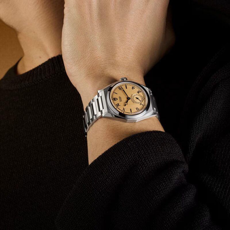 Tudor Monarch worn on the wrist with black knitwear sleeve