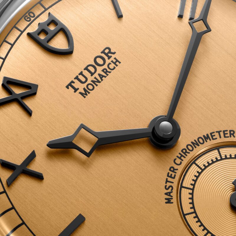 Macro close-up of the champagne textured California dial of the Tudor Monarch