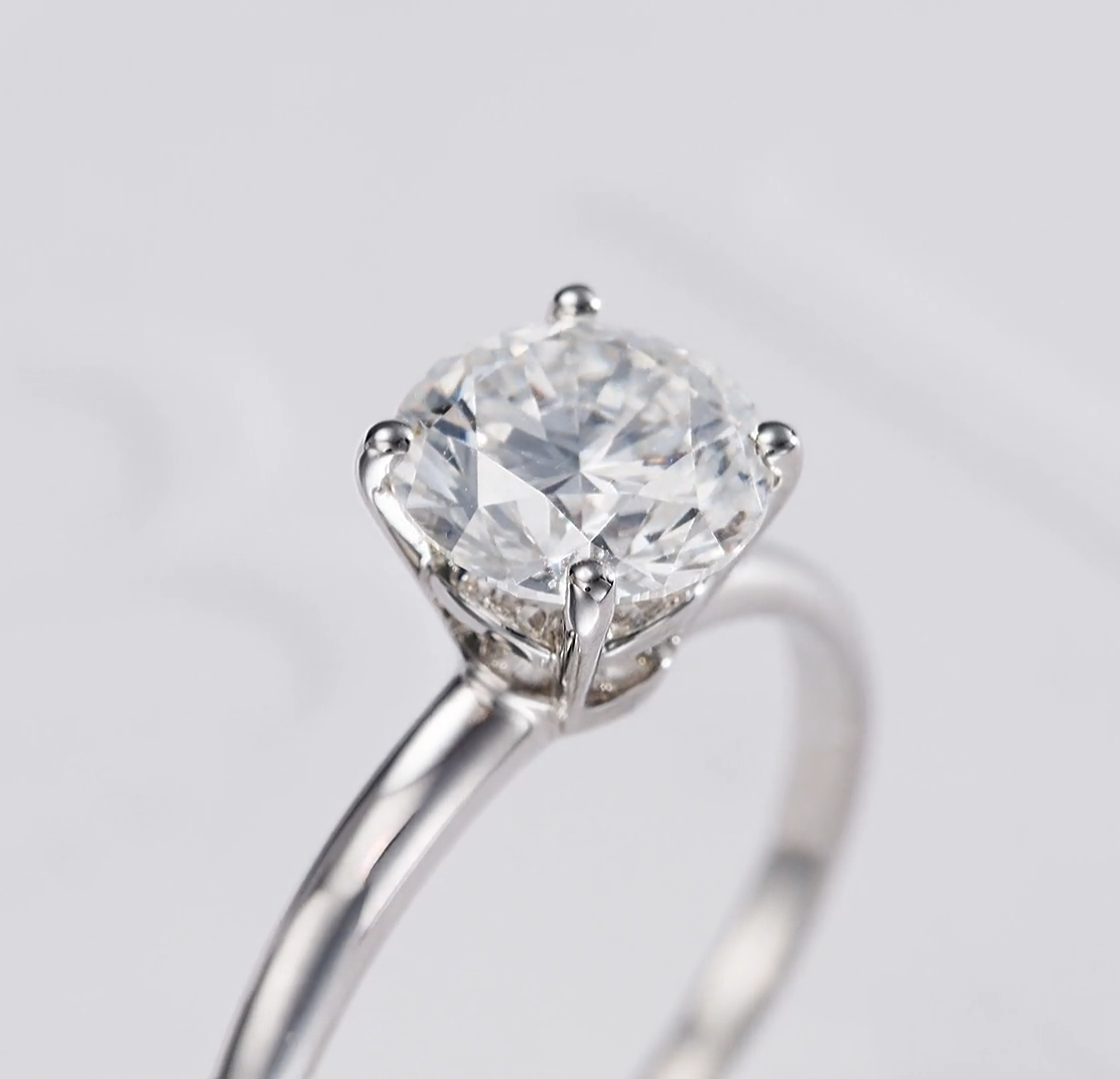 Macro close-up view of the four-prong claw setting and diamond facets of a Bulgari solitaire engagement ring