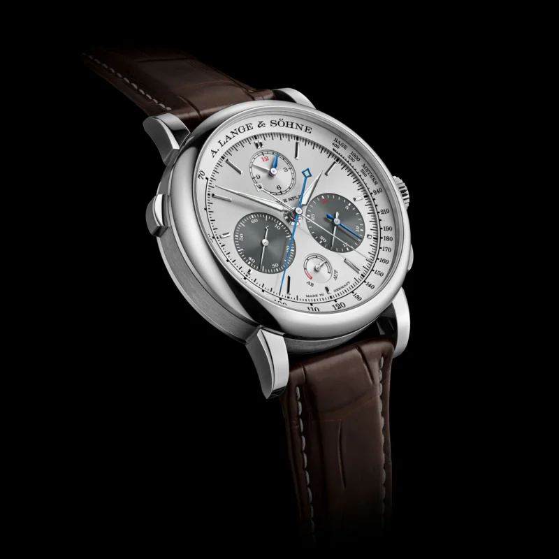 Three-quarter view of the Triple Split showing its pushers and platinum case