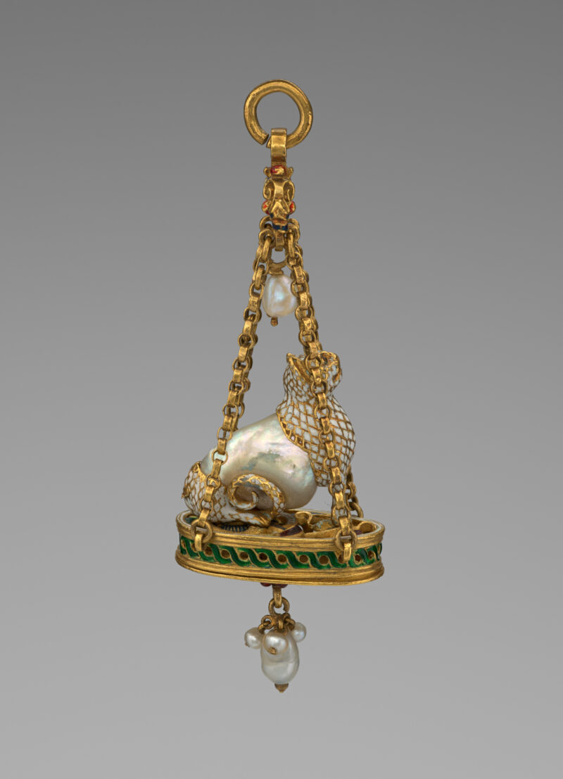 Reverse of a historic cat pendant showing construction