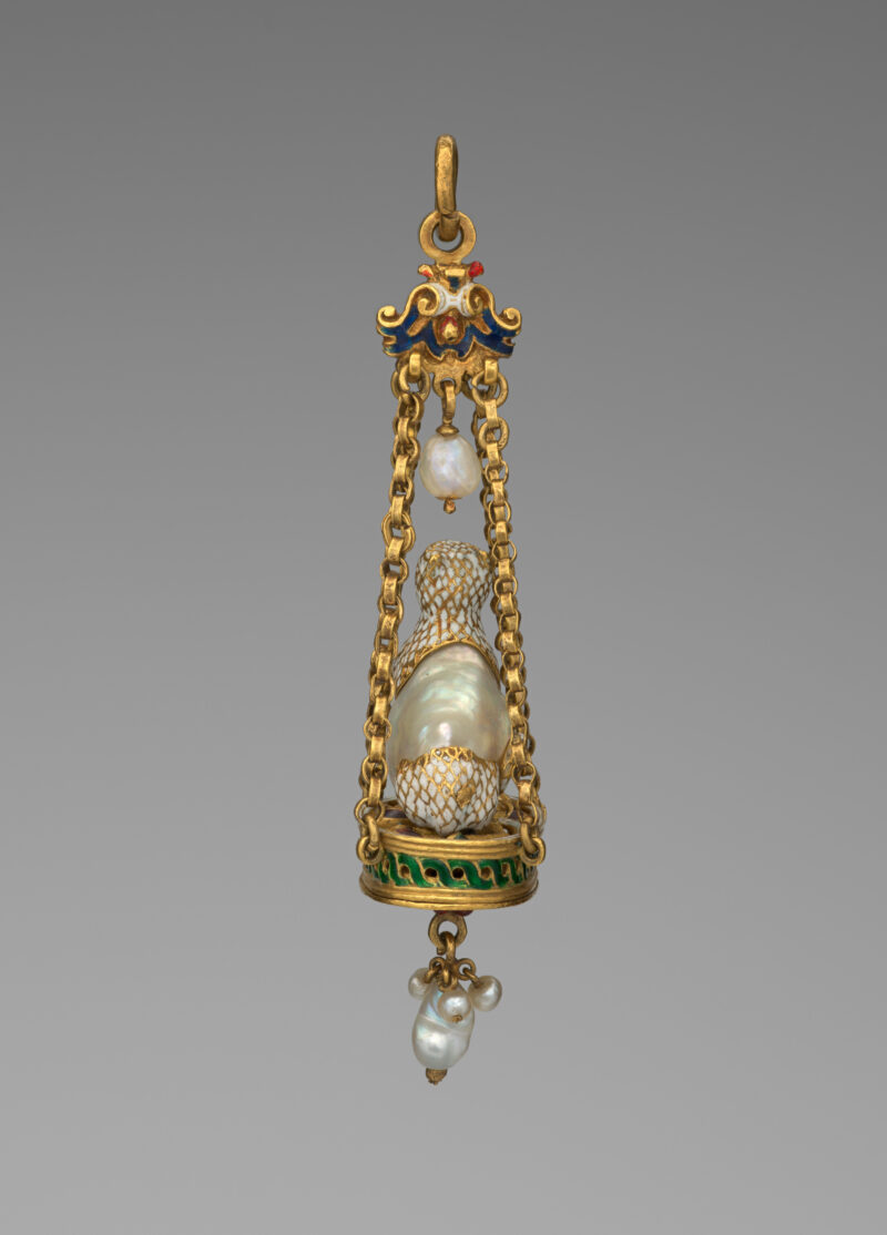 Side view of a historic cat pendant