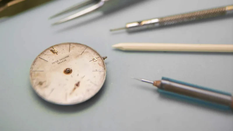 Patek Philippe restoration workbench with dial and tools