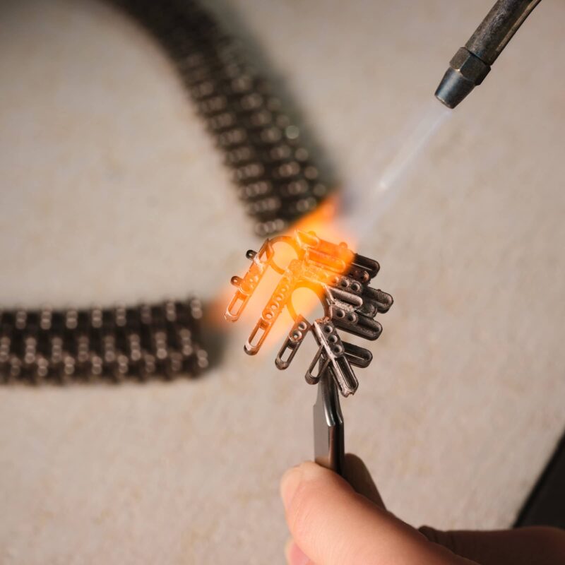 Piaget artisan heating a high jewellery frame