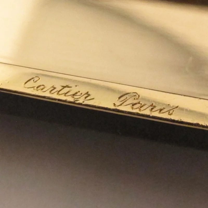 Macro photograph of a Cartier signature on a jewel