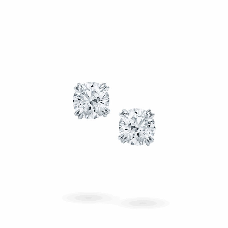 Pair of Harry Winston round brilliant diamond earstuds viewed from the front.