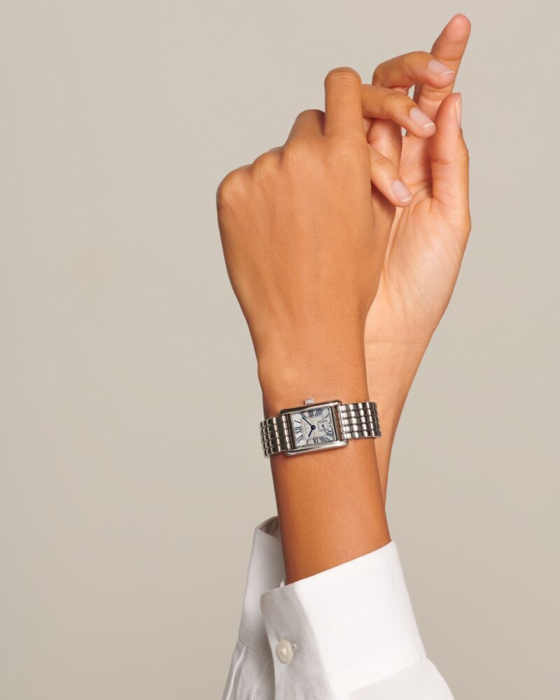 Longines Mini DolceVita L5.200.4.71.6 on a raised wrist above a white cuff.