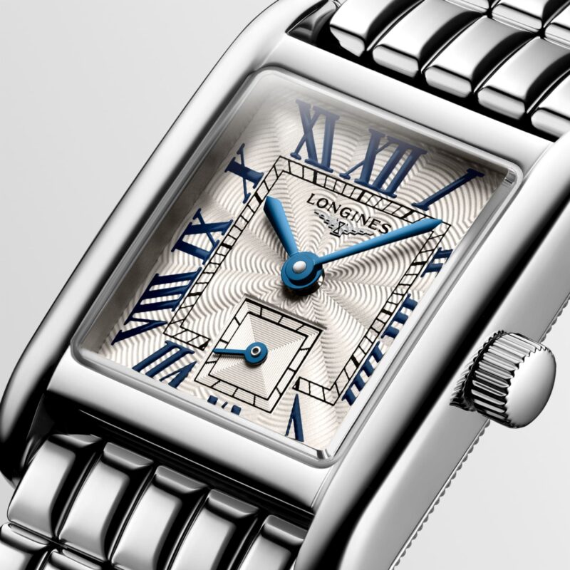 Close view of the silver flinqué dial, blue hands and Roman numerals of Longines Mini DolceVita.