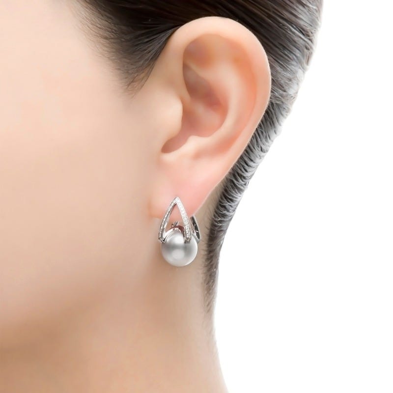 Mikimoto M Collection white South Sea pearl earring shown on the ear.