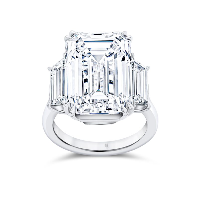 Norman Silverman emerald-cut diamond three-stone ring with trapezoid side diamonds.