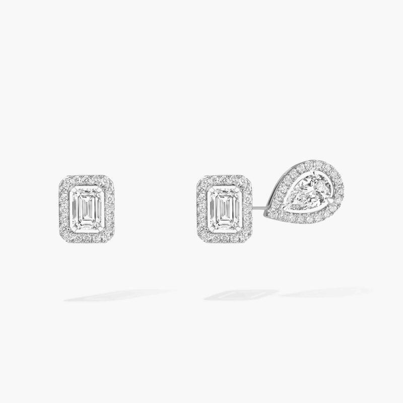Two white-gold earrings, one with a rectangular diamond and the other with a rectangular and pear-shaped diamond.