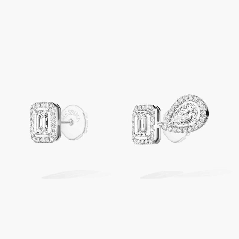 Angled view of the asymmetric earrings, showing the posts and backs behind the settings.