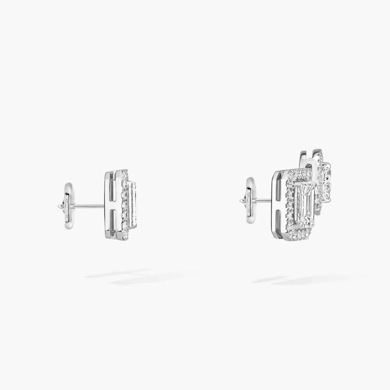 Side view of two earrings with posts and a second element behind the double setting.