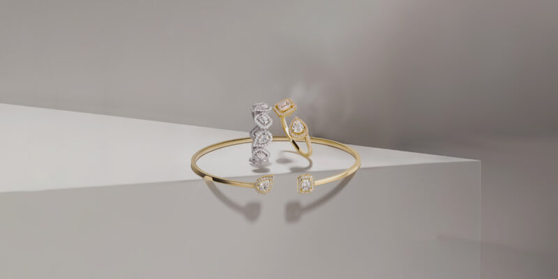 My Twin rings and an open bangle arranged on pale architectural blocks.