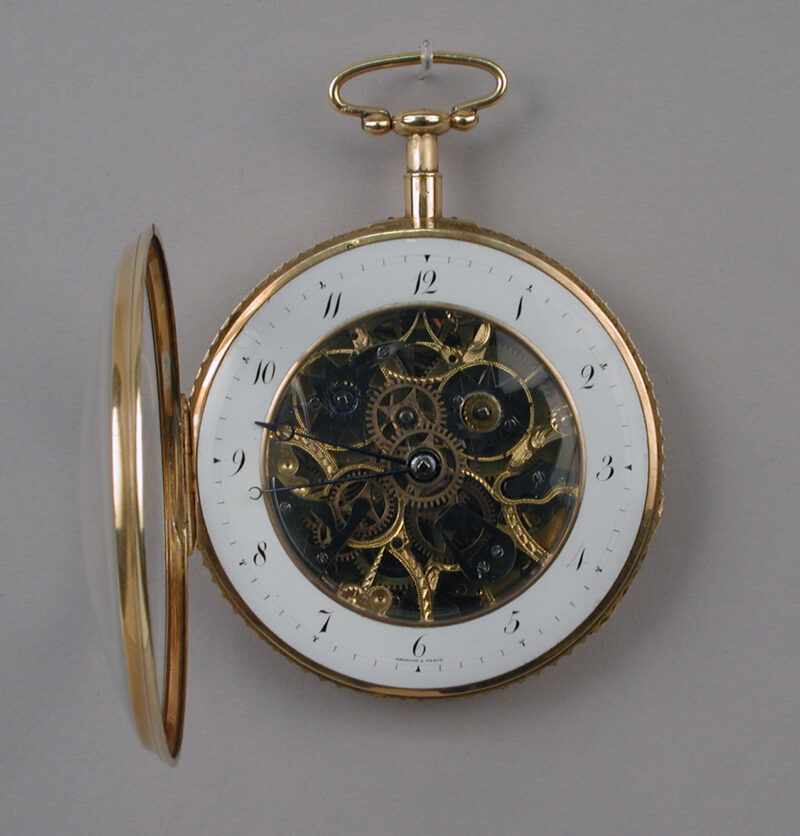 Gold skeleton watch with a white hour ring and an open cover.