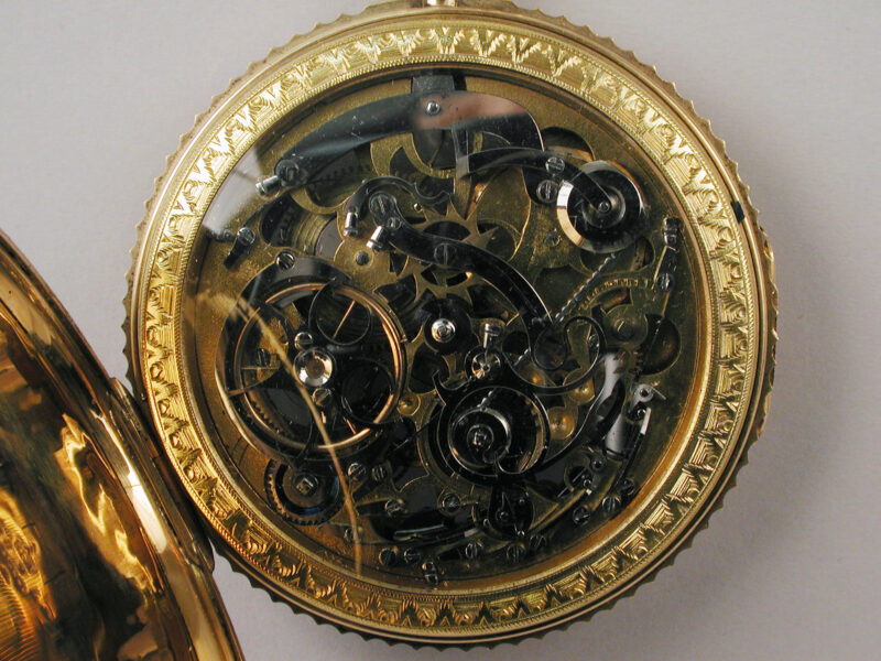 Closer view of the skeleton watch mechanism and its decorative gold rim.